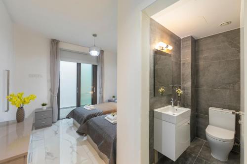 a bathroom with a bed and a toilet and a sink at Villa Andromeda, Sea Caves in Peyia