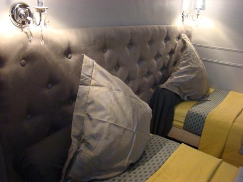 a bedroom with a bed with a padded headboard at " Chimay B & B " - ptits déj gourmands proposés in Chimay