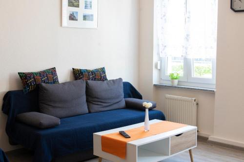 a living room with a blue couch and a coffee table at Niedersburger Eck, wandern, radfahren, genießen, erholen in Boppard