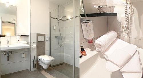 a bathroom with a shower and a toilet and a sink at Hotel-Gasthof Rangau in Ansbach