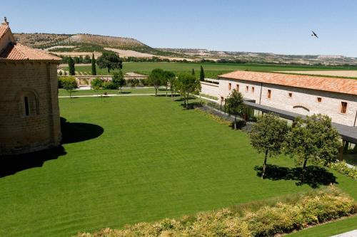 an aerial view of a large green yard with buildings at Abadia Retuerta LeDomaine in Sardoncillo