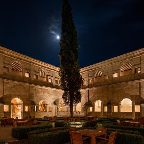 a building with a tree in front of it at night at Abadia Retuerta LeDomaine in Sardoncillo