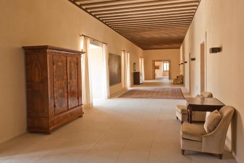 a hallway with a couch and a table in a room at Abadia Retuerta LeDomaine in Sardoncillo