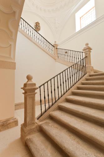 a staircase in a home with a white ceiling at Abadia Retuerta LeDomaine in Sardoncillo