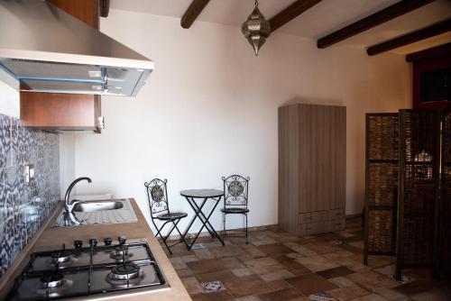 a kitchen with a stove and a counter top at CASE VACANZE I QUATTROVENTI in Lampedusa