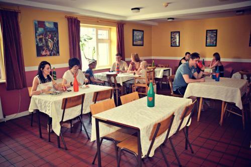 
a large group of people sitting around a dining room table at Neptune's Hostel in Killarney
