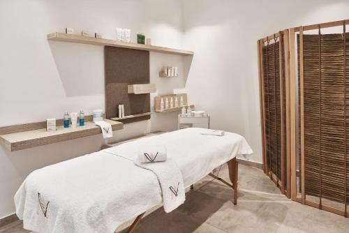 a hospital room with a bed and a window at Volcano Luxury Suites Milos - Adults Only in Paliochori
