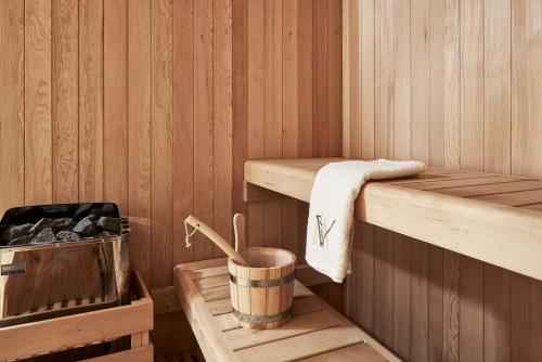 a wooden interior of a sauna with a bucket at Volcano Luxury Suites Milos - Adults Only in Paliochori