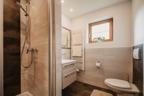 a bathroom with a shower and a toilet at DAS "Bergzeit" - Appartements in Wagrain