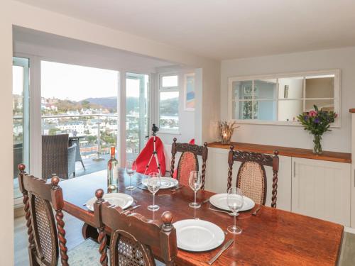 a dining room with a table and chairs and a window at Windwhistle in Dartmouth