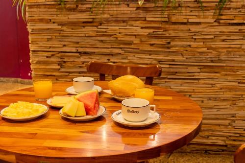 a wooden table topped with plates of food at Pompeu Rio Hotel in Rio de Janeiro