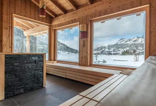 a room with a view of a snowy mountain at Hotel Tyrol am Haldensee in Haldensee