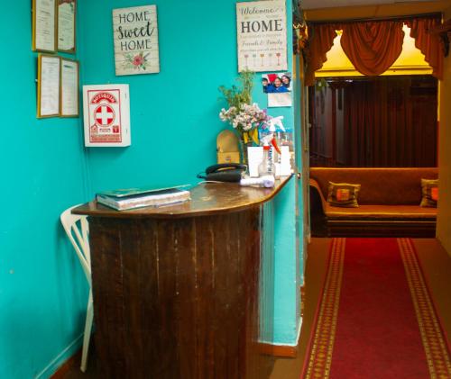 a blue room with a wooden counter in a house at Hostal Casa Del Inka in Cusco