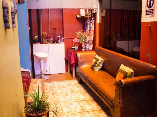 a living room with a couch and a table at Hostal Casa Del Inka in Cusco