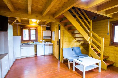 a kitchen with a staircase and a blue chair in a room at Ośrodek Wypoczynkowy AKWA Marina in Nysa