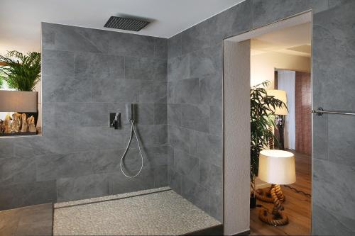 a bathroom with a shower with a shower head at Private Spa LUX with Whirlpool and Sauna in Zurich in Zurich
