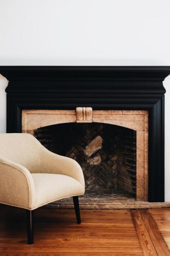 a chair sitting in front of a fireplace at Bidaia Boutique Hotel in Donostia-San Sebastián