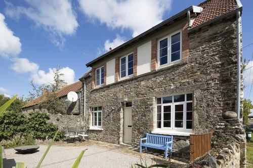 a stone house with a blue bench in front of it at Glatigny Farmhouse - close to beach - proche de la plage in Glatigny