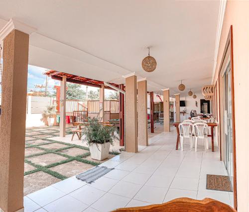 een open veranda met een tafel en stoelen bij Pousada Ventos da Barra in Barra de Santo Antônio