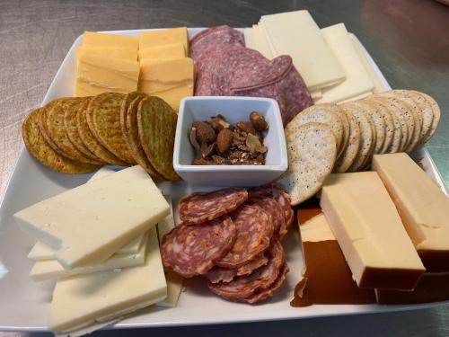 a plate of different types of cheese and nuts at Inn On The River in Glen Rose