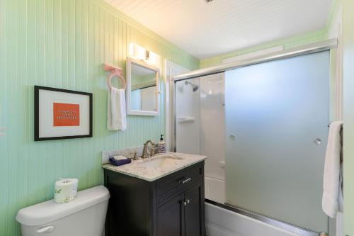 a bathroom with a shower and a sink and a toilet at 1684 E Ashley - Sol Searcher - 2 Bedrooms in Folly Beach