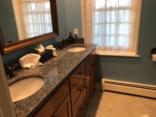 a bathroom with two sinks and a mirror at Cider House Bed and Breakfast in Waynesboro