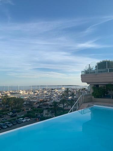 a pool on the roof of a building with a view at Palais Napoléon, Golfe Juan in Vallauris