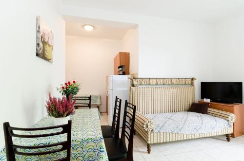 a living room with a table and a refrigerator at Apartments Massimo in Rovinj