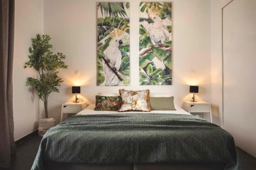 a bedroom with a large bed with two posters on the wall at Casa Maria in Lithakia
