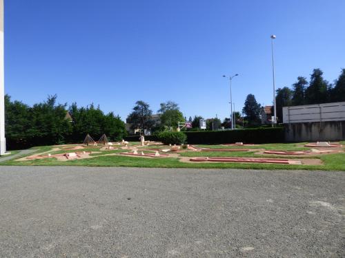 a park with a playground with rocks and trees at Cit'Hotel Escatel in Mâcon