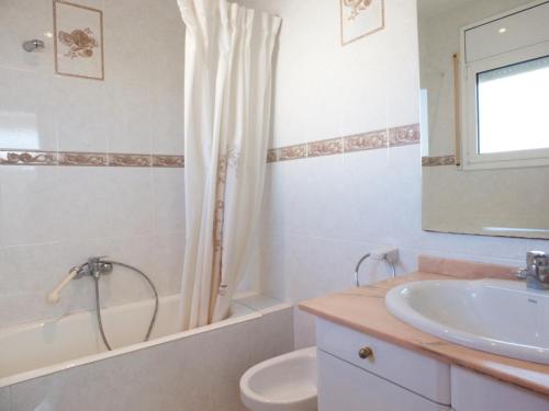 a bathroom with a sink and a tub and a toilet at Villa Nerea with air conditioning & private swimming pool only 400m to the beach ideal for families in L'Ametlla de Mar