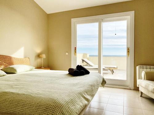 L'Ametlla de MarにあるVilla Catalina Stunning 4bedroom villa with air conditioning sea views & private swimming pool ideal for familiesのベッドルーム1室(ベッド1台、大きな窓付)
