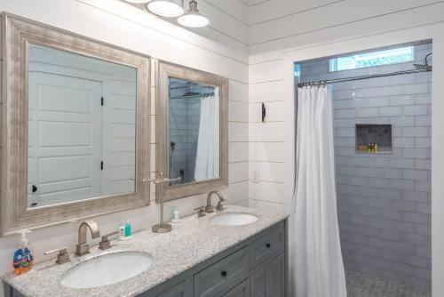 a bathroom with two sinks and a shower at 316 E Hudson - The High Tides - Hot Tub - 4 Bedrooms in Folly Beach