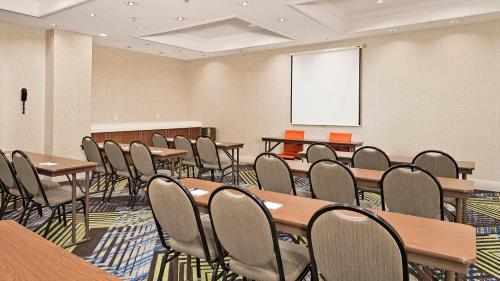 a conference room with tables and chairs and a whiteboard at Holiday Inn Express Hotel and Suites Conroe by IHG in Conroe