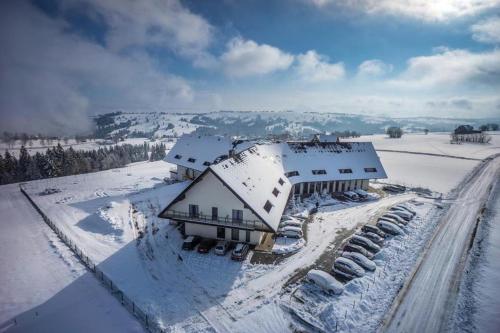 an aerial view of a house covered in snow at Hotel Bachledówka in Zakopane