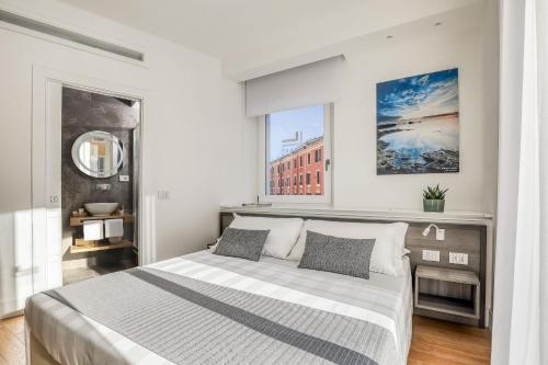 a bedroom with a large bed and a window at Gallery Suite in Civitavecchia