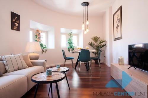 a living room filled with furniture and a tv at Malaga Center Flat Luxury in Málaga