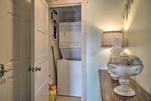 a hallway with a refrigerator and a table with a lamp at Unwind Fireside Ozark Mtn Condo with Resort Perks! in Branson