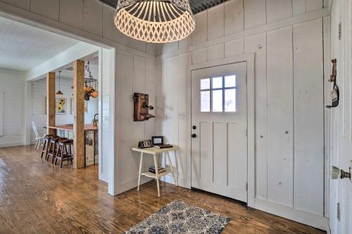 a room with a door and a table and a chandelier at Pool, Hot Tub and Game Room Schulenburg Retreat in Schulenburg