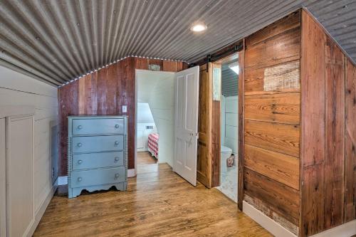 a room with wooden walls and a hallway with a dresser at Pool, Hot Tub and Game Room Schulenburg Retreat in Schulenburg
