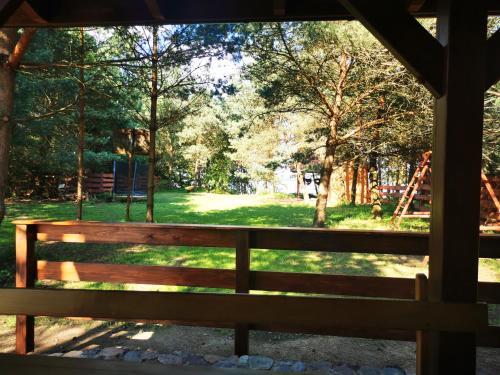 a view of a park through a wooden fence at Ostoja Stacze in Stacze