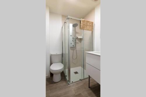 un bagno con wc e doccia in vetro di Suite by Hawkins interior 2A a Algeciras