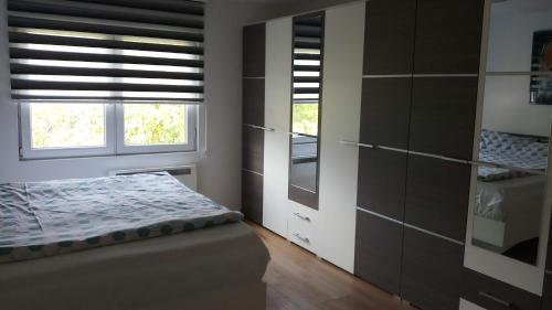 a bedroom with a bed and a window at Vikend kuća Careva Ćuprija-apartman in Olovo