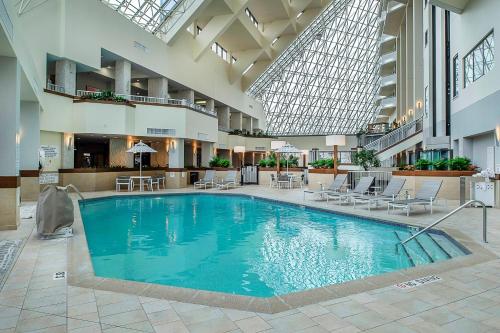 a large swimming pool in a hotel lobby at Crowne Plaza Hotel St. Louis Airport by IHG in Bridgeton