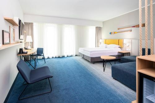 a hotel room with a bed and a couch at Holiday Inn Gdansk - City Centre by IHG in Gdańsk