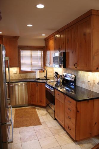 a kitchen with wooden cabinets and a black counter top at Vail Racquet Club Mountain Resort in Vail