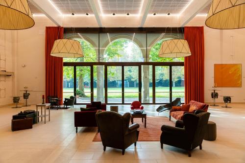 a large living room with a large window at La Barchessa di Villa Pisani in Lonigo