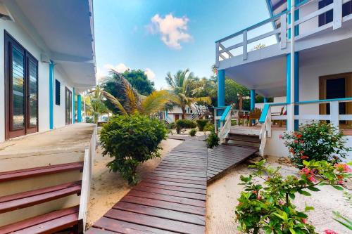a wooden walkway in front of a building at Beachside Villas Gold Standard Certified in Placencia Village