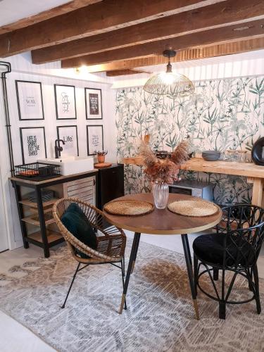 a dining room with a table and two chairs at Studio de charme proche de la gare, et du centre ville in Rennes