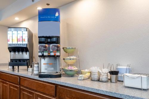a counter with a coffee maker on a counter at HomeTown Inn by Red Roof East Syracuse in East Syracuse